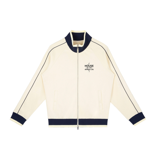 Cream-colored jacket with navy accents on a white background